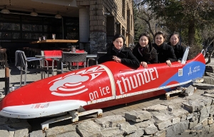 Dancers (from left) Diana Teng, Eva Su, Sophia Chang, and Hannah Jao huddle in a bobsled. (Photo by dancer Yuxuan Liu)