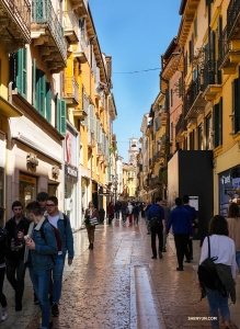 A busy but charming pedestrian street in Verona, Italy.