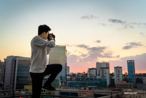 Principal Dancer William Li tries to capture the sun setting from his balcony. (Photo by dancer Daniel Jiang)